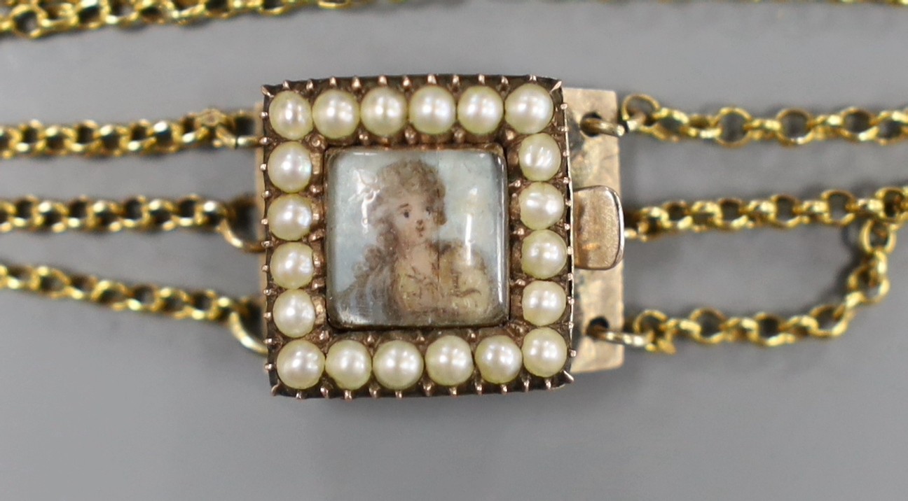 An early 19th century seed pearl set gold bracelet clasp, inset with a miniature of a lady, 1.5cm, on later? triple chain bracelet, gross 7.6 grams